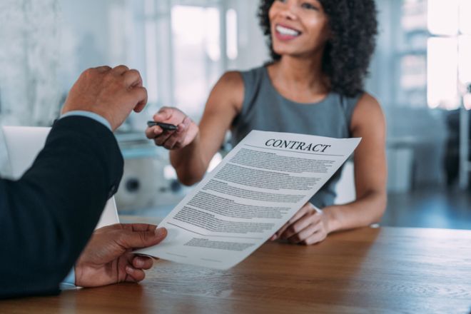 Business people signing a contract in the office.