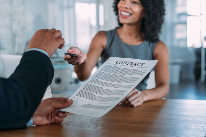 Business people signing a contract in the office.