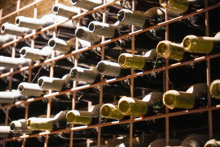 Rustic Wine Cellar Rack Filled with Bottles of Aged Wine Close Up View