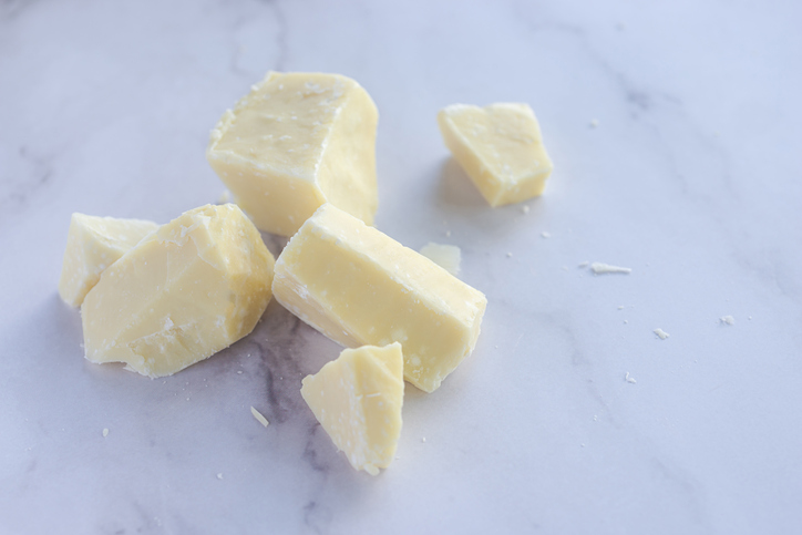 cocoa butter on marble table background.