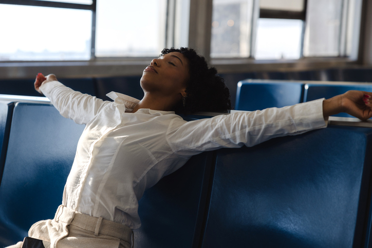Woman resting on the ferry boat seats during the daily commuting to the city