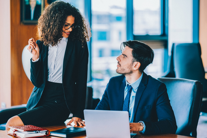 Businesswoman flirting with her colleague in the office