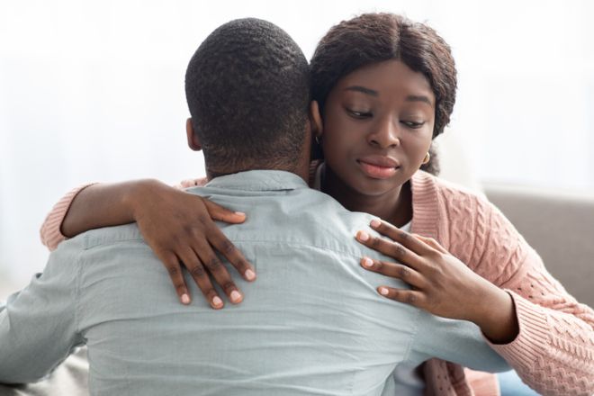 Dishonest black lady hugging her boyfriend or husband