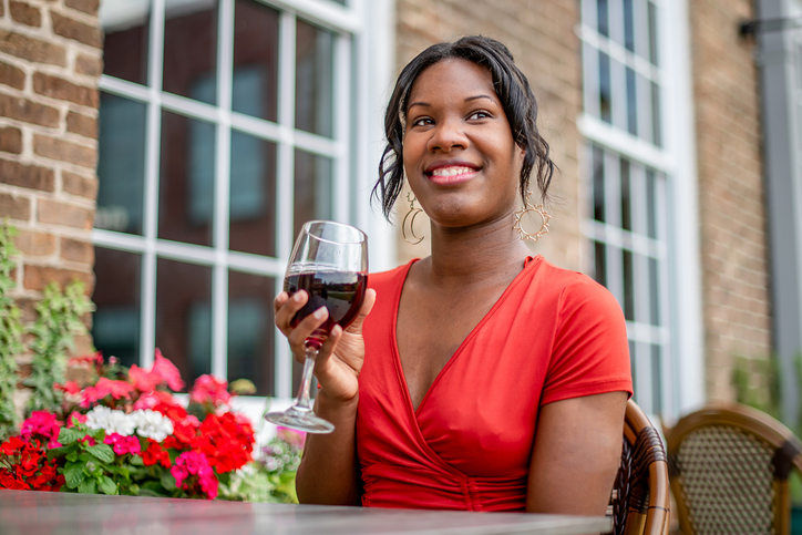 Beautiful woman Relaxing with a glass of Wine Outdoors