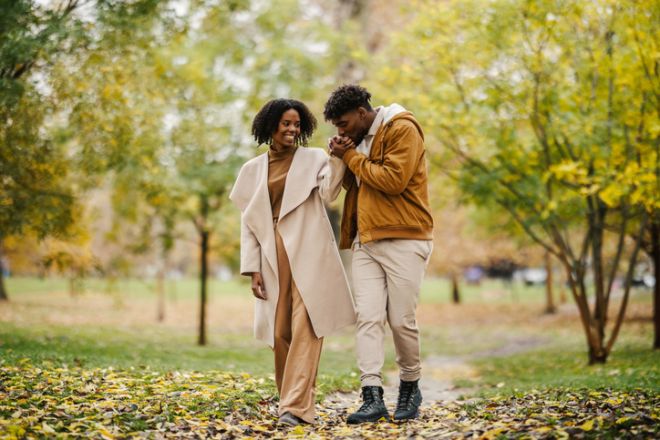 Young black couple enjoying romantic autumn park walk