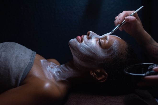 Woman is getting facial mask for skin care treatment.