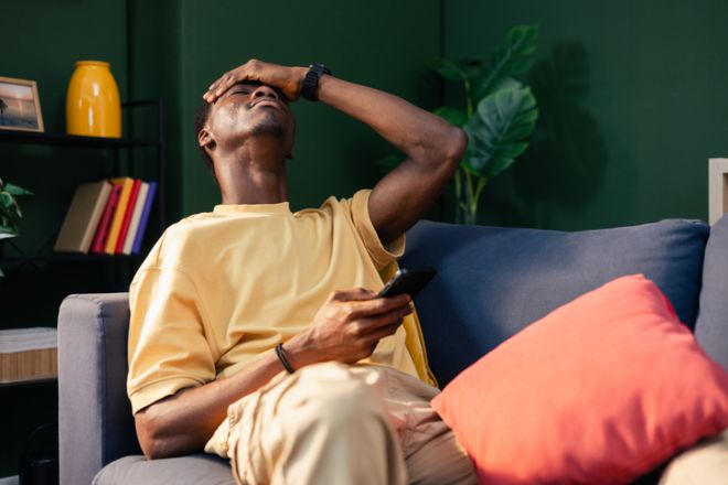 Man feeling upset, desperate, and frustrated with smartphone