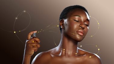 Woman applying fragrance in beauty studio with soft lighting and elegant atmosphere