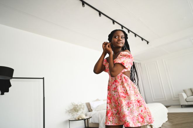 Young woman in front of mirror.