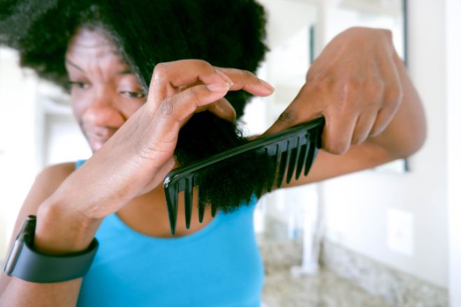 Woman Uses Wide-Tooth Comb to Detangle Wet Natural Hair