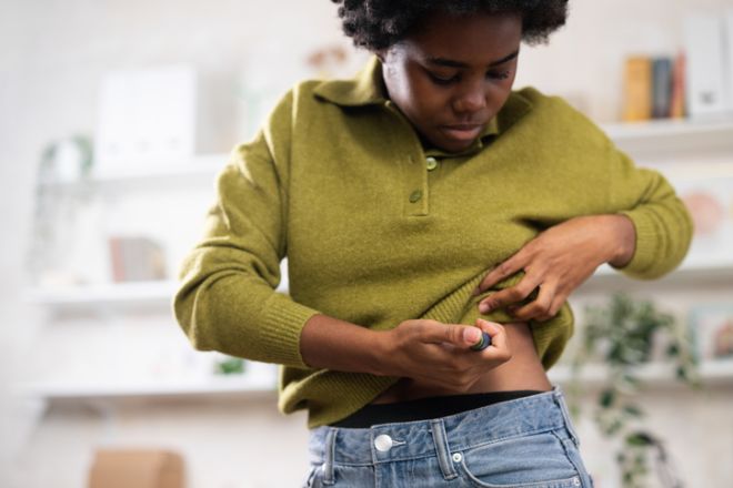 Black woman injecting insulin for diabetes self-care treatment