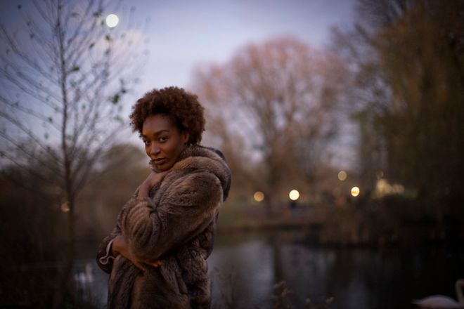 Portrait beautiful young woman in moonlit park at night