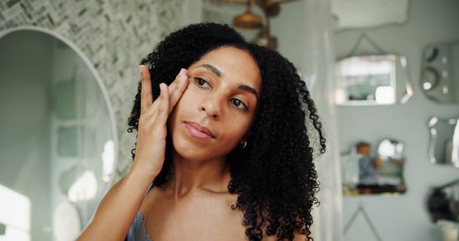 Skincare, facial or woman in home with shine, hydration or vitamin benefits for soft skin. Dermatology, glow or girl in bathroom with application, collagen or radiance in anti aging treatment.