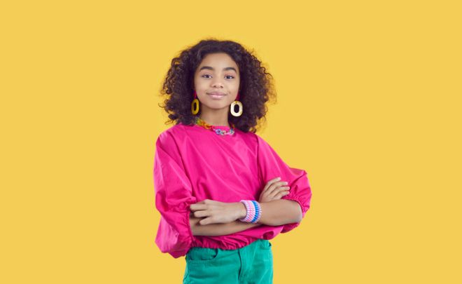 Studio portrait of happy beautiful African American child model in trendy clothes
