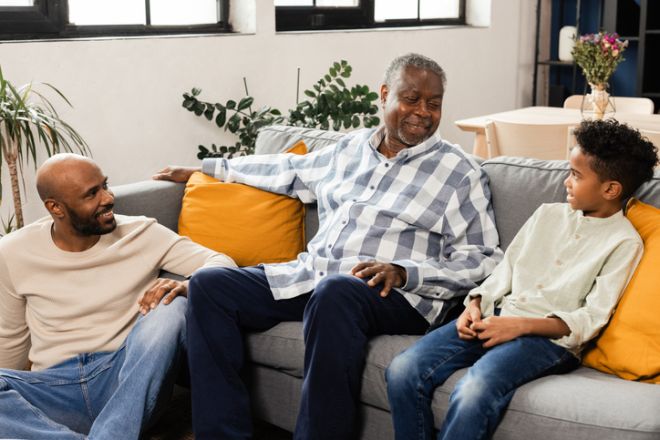 African-american multi-generational family talking on sofa at home