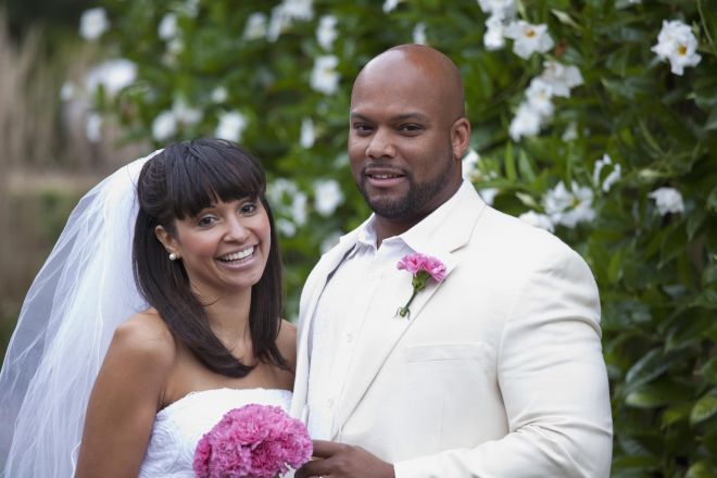 Smiling Black bride and groom on wedding day