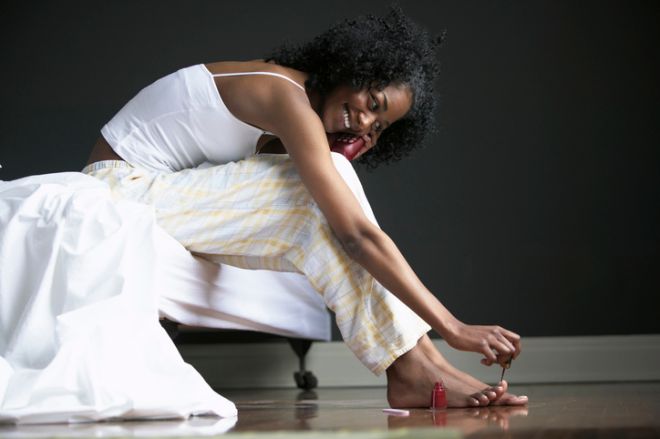 Woman Painting Toenails While on the Phone