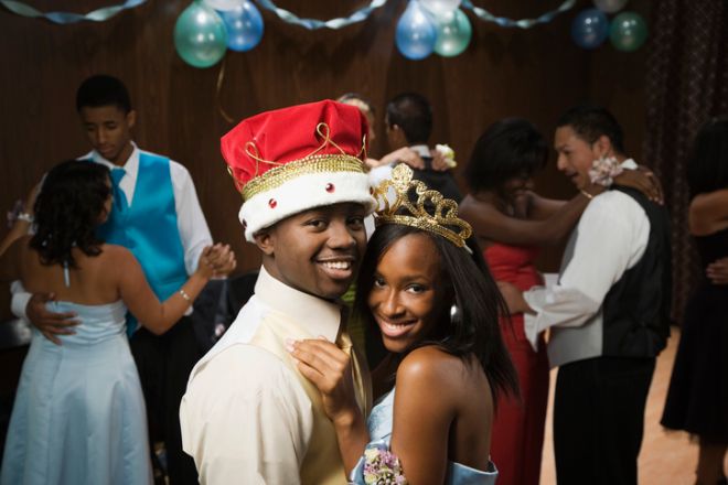 African prom king and queen dancing