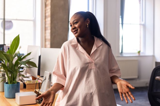 Pregnant Woman at Office Desk Looking Away