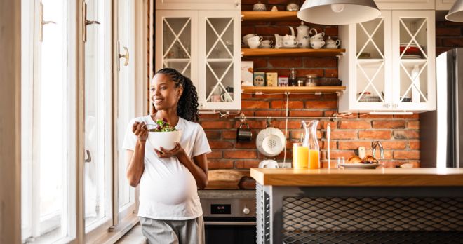 Beautiful Black Pregnant Woman Enjoying Quiet Home Moment Eating Breakfast