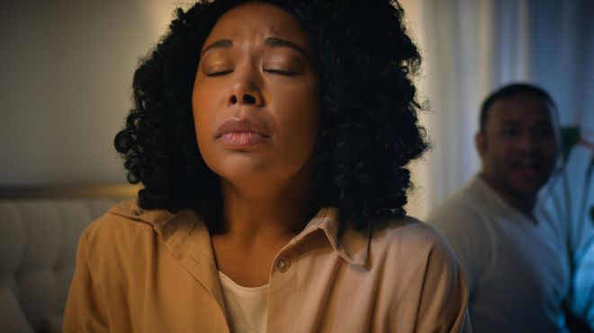 Suffering upset sad depressed anxious frustrated domestic violence victim African American woman wife separated apart listen angry mad screaming shouting blame man husband couple conflict in bed drama