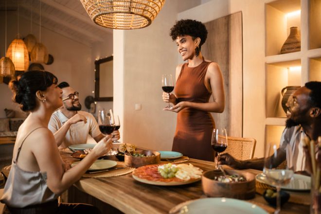Friends Enjoying Dinner – Host Raising a Toast