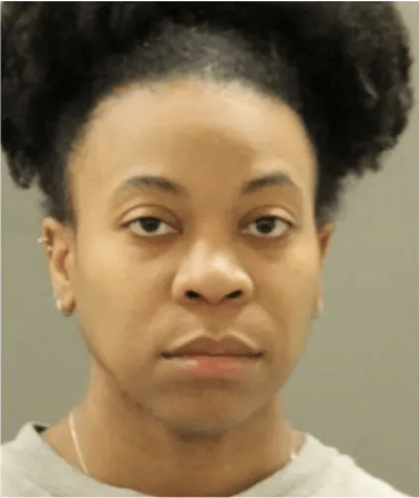 A close-up portrait of a young African American woman with curly hair and a serious expression.