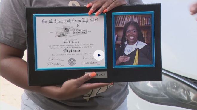 A person holding a framed diploma from Gary M. Sterne Early College High School and a photo of a smiling graduate wearing a graduation gown and cap.