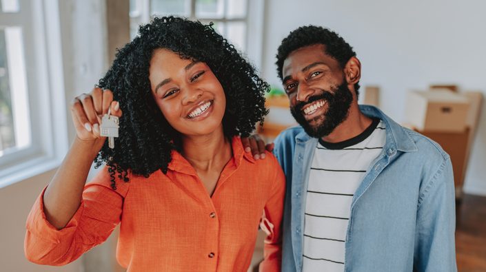Moving into a new home, a happy couple smiling