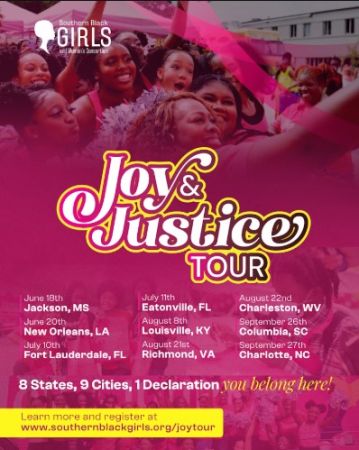 Crowd of people, mostly young women, holding pink and white signs at an event called the "Joy & Justice Tour" in various cities across the United States.