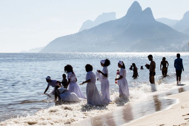 Devotees pray and jump waves in celebration of Iemanjá, the