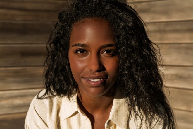 Young adult black woman smiling looking at camera