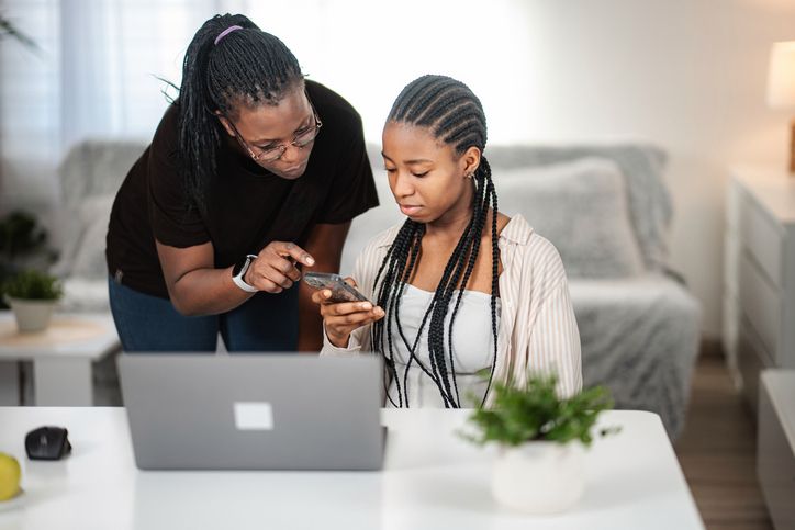 Mother and daughter learning technology at home
