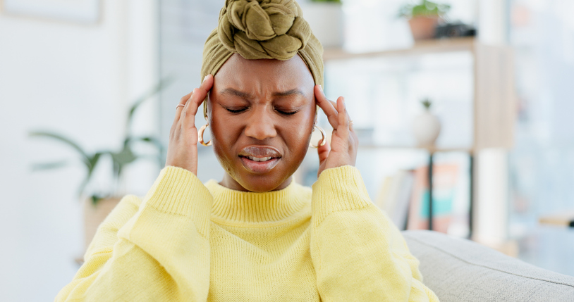 Headache, pain and black woman in home, tired and health risk with pressure in living room. Apartment, brain fog and African person with stress, migraine or tension with fatigue, crisis or burnout