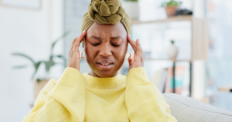 Headache, pain and black woman in home, tired and health risk with pressure in living room. Apartment, brain fog and African person with stress, migraine or tension with fatigue, crisis or burnout