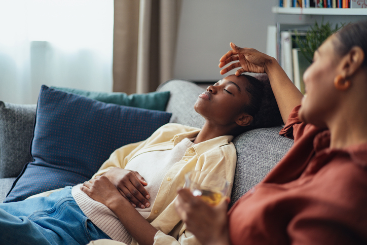 Mother and Teenage Daughter Relaxing Together at Home on a Couch in a Warm Family Moment