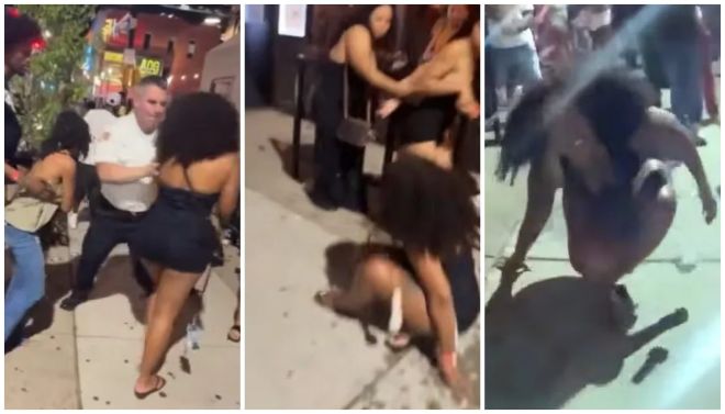 A group of people engaged in a physical altercation on a city street at night, with one person on the ground and others standing around them.