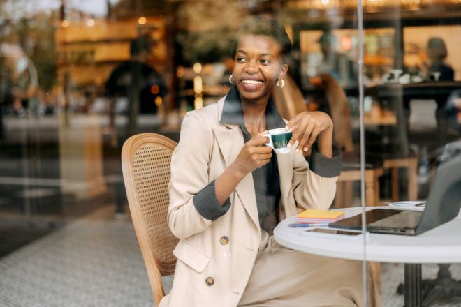 Young Black Businesswoman Enjoying Coffee While Working Remotely in a Cafe