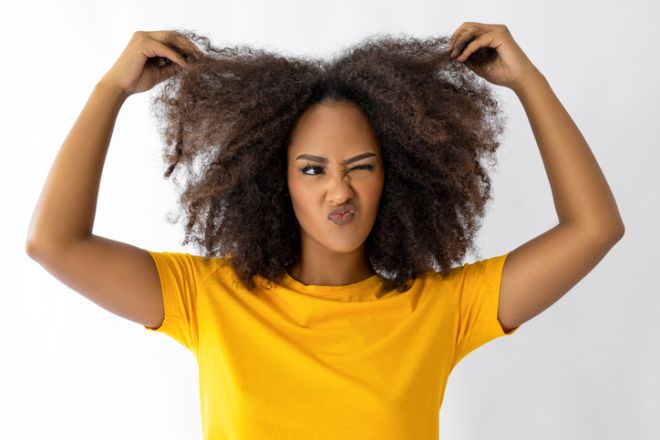 Female with afro hair pulling her hair
