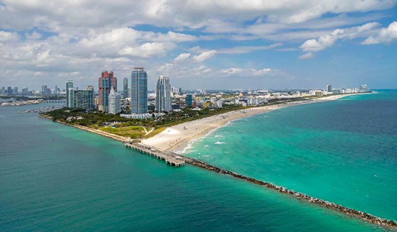 Miami seaside with turquoise ocean and sky. Miami city. Famous oceanfront of Miami. Miami Beach skyline.