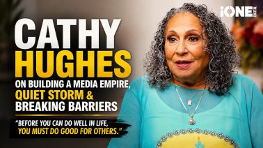 Cathy Hughes, a media executive, posing for a portrait with a warm expression and colorful jewelry.