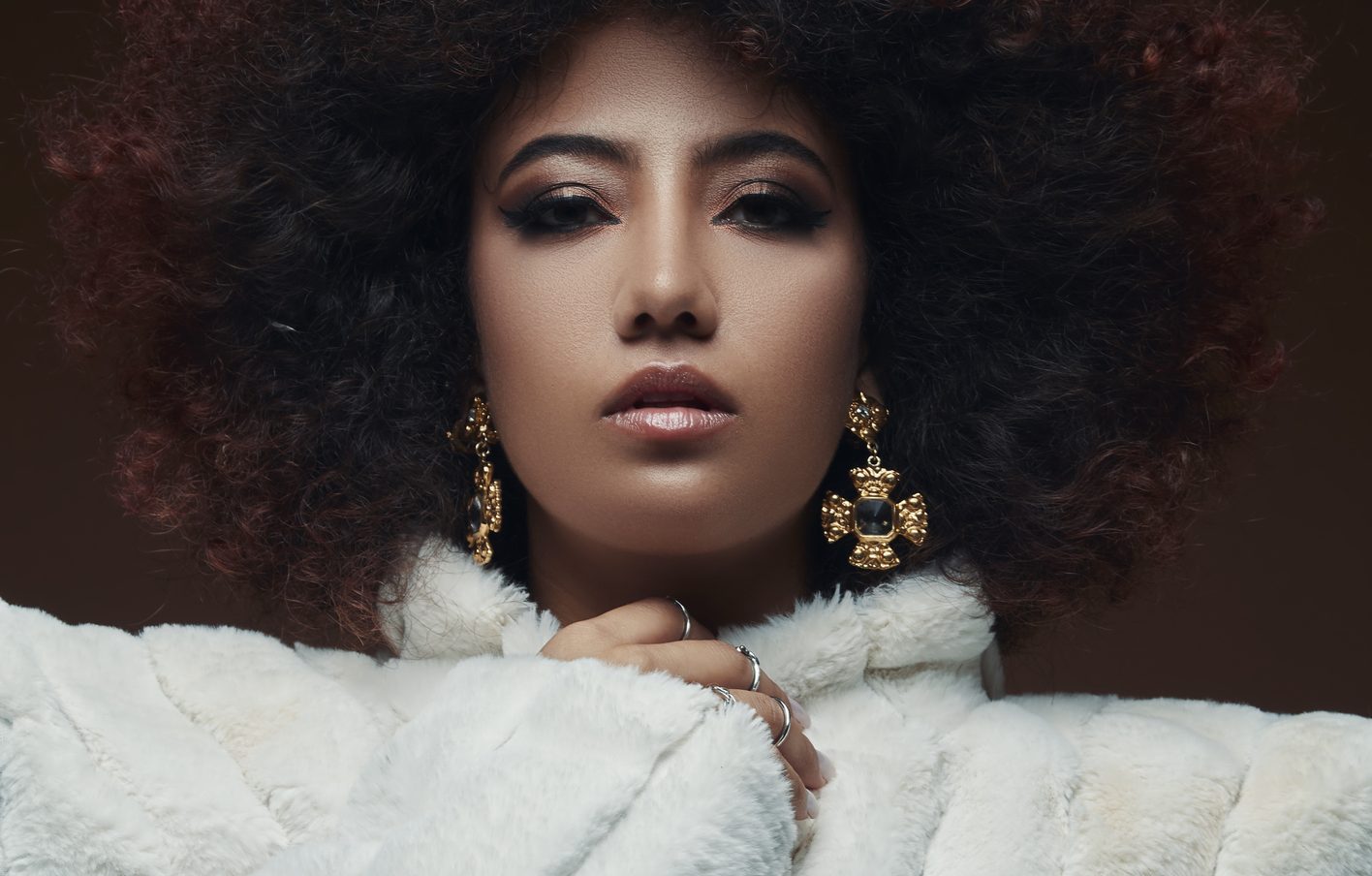 Curly-haired mixed-race young woman.