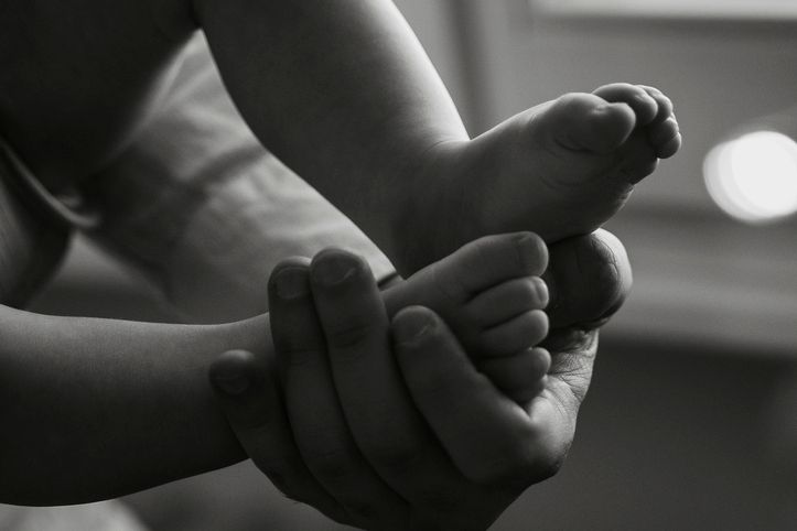 Close-Up of Baby Feet in Gentle Hands