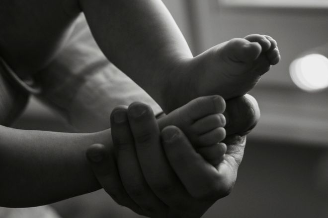 Close-Up of Baby Feet in Gentle Hands